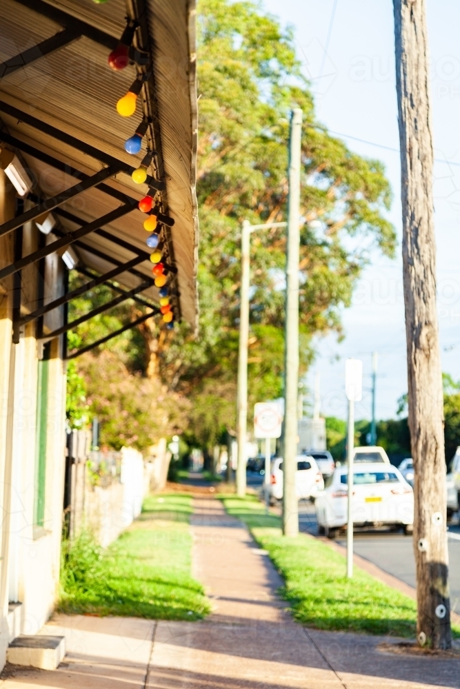 Colourful lights along awning of corner store - Australian Stock Image