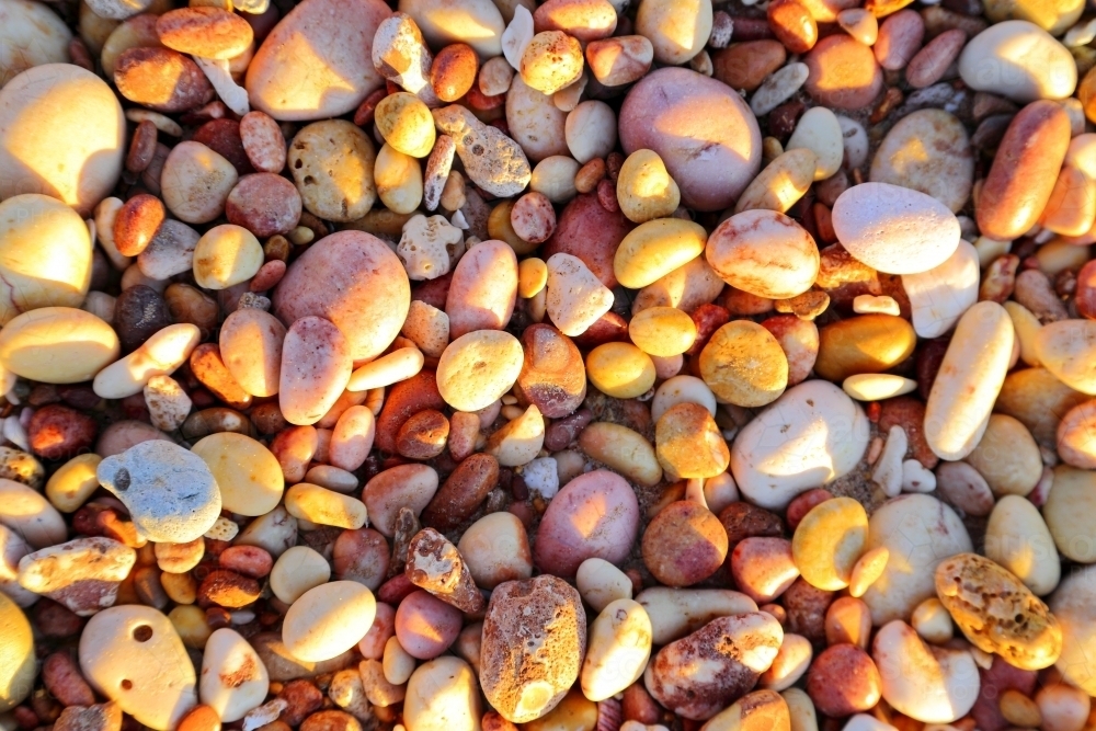 Colourful pebbles along the shore of Pebble Beach. - Australian Stock Image