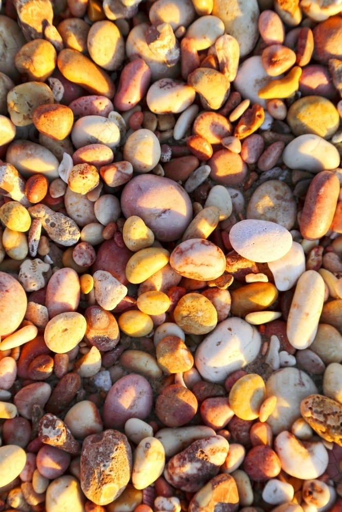 Colourful pebbles along the shore of Pebble Beach. - Australian Stock Image