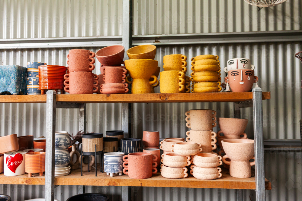 Colourful plant pots for sale in shed at nursery small business - Australian Stock Image