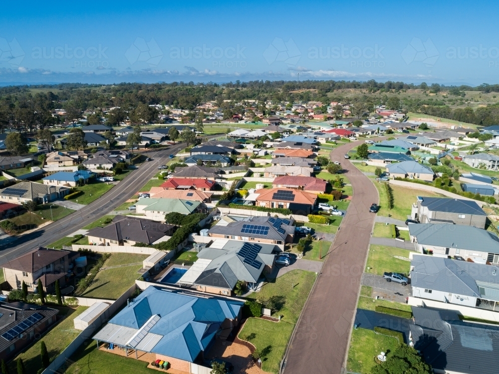 Colourful rooves of houses lining street in residential area of small town - Australian Stock Image