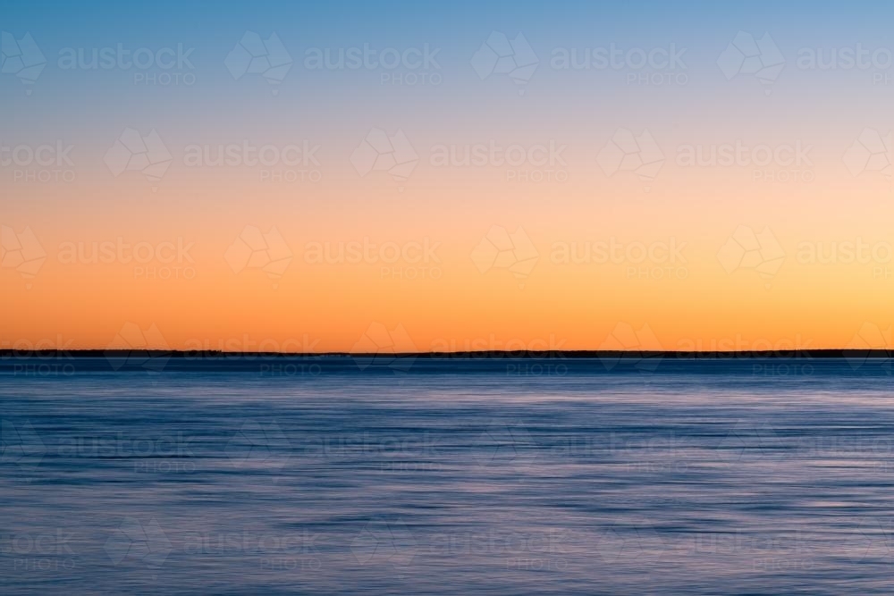 Colourful sunset over water - Australian Stock Image