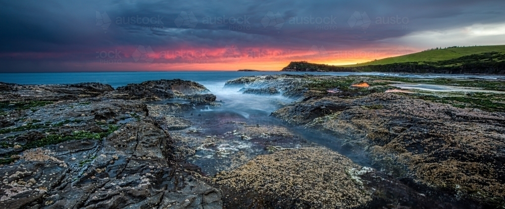 Colourful sunset views from a coastal rock platform - Australian Stock Image