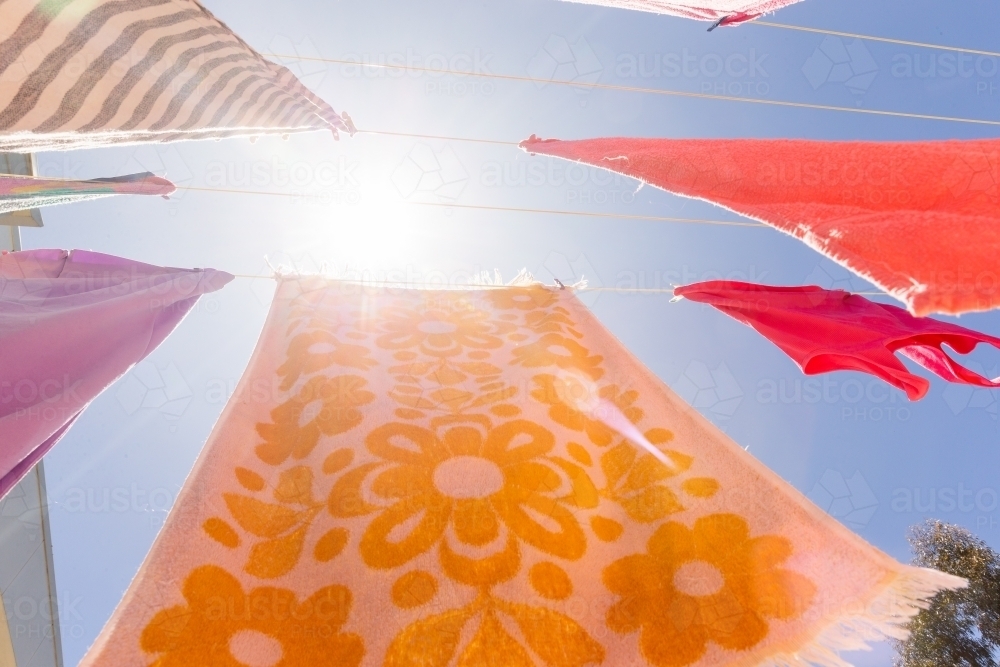 Colourful towels and swimmers hanging on washing line - Australian Stock Image