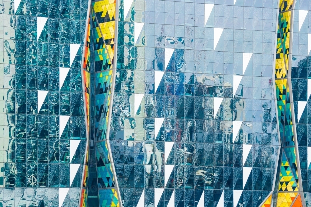 Colourful triangular glass windows on the side of a buildings - Australian Stock Image