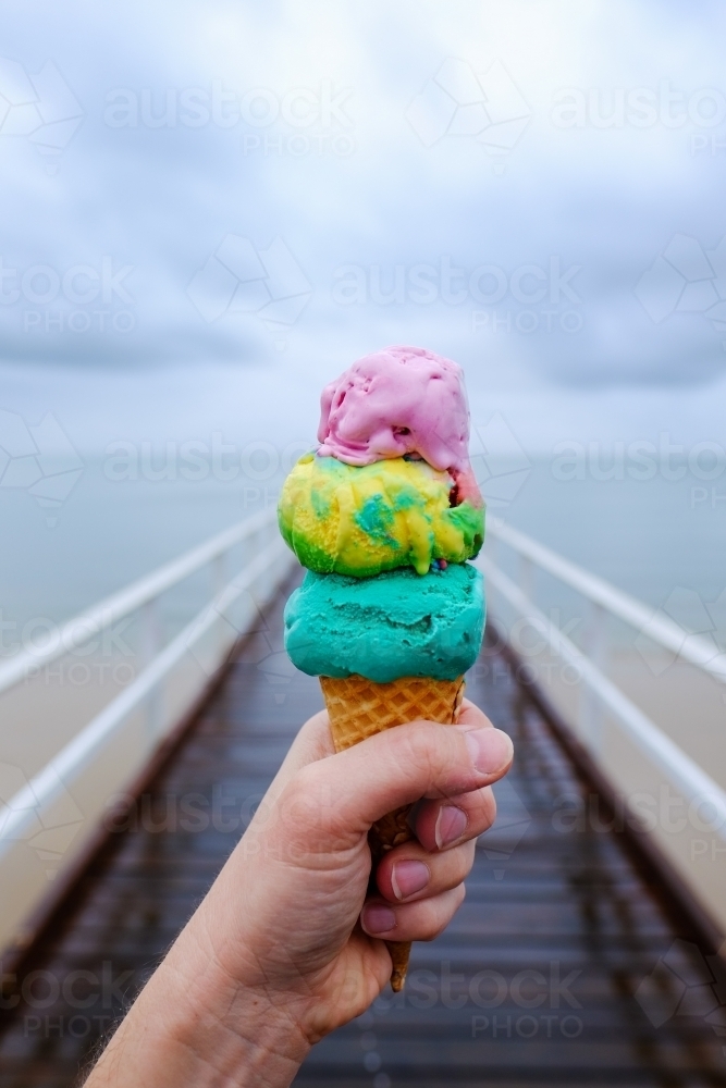 Colourful triple scoop ice cream on a jetty at Hervey Bay - Australian Stock Image
