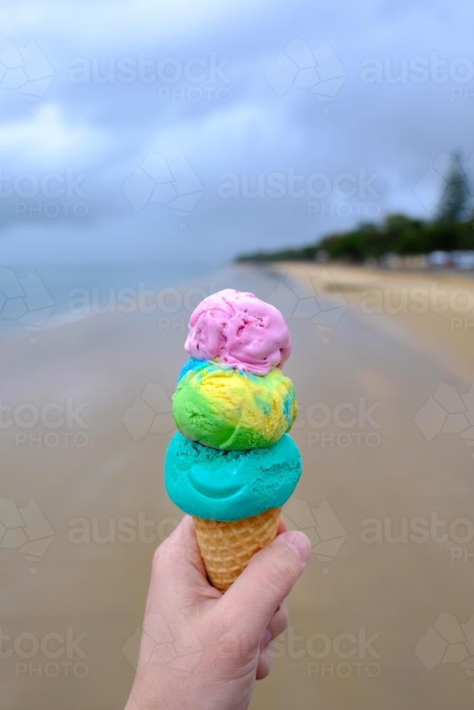 Colourful triple scoop ice cream on the beach at Hervey Bay - Australian Stock Image