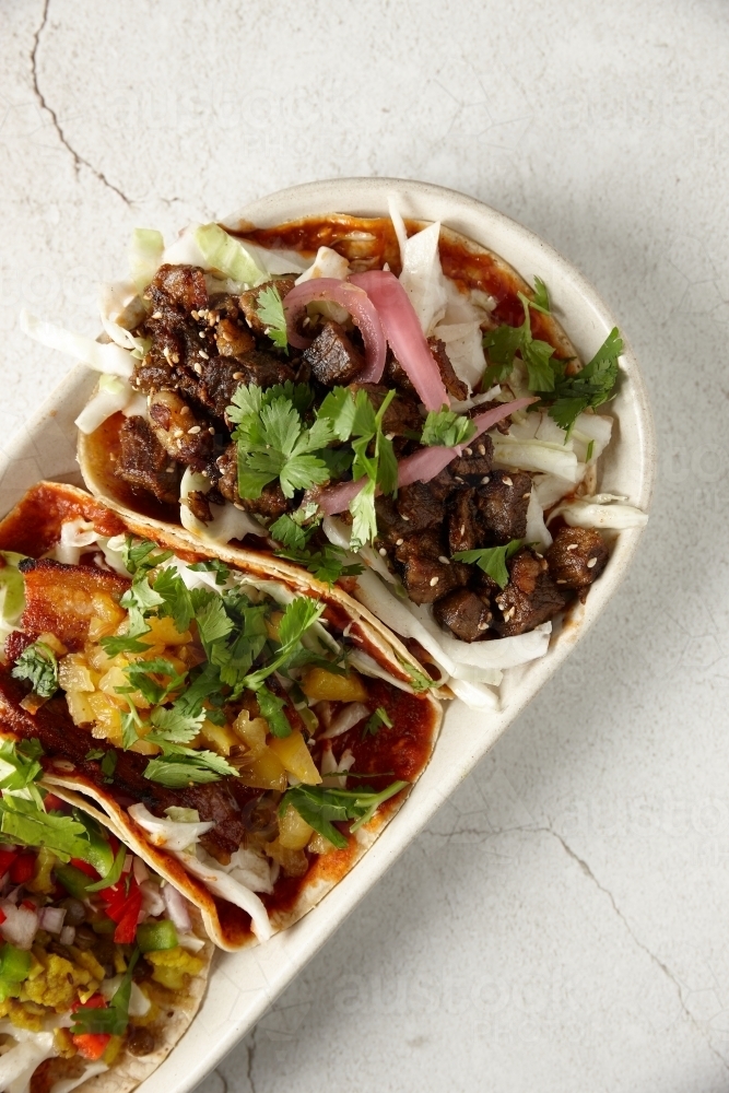 Colourful variety of meat tortillas on plate - Australian Stock Image