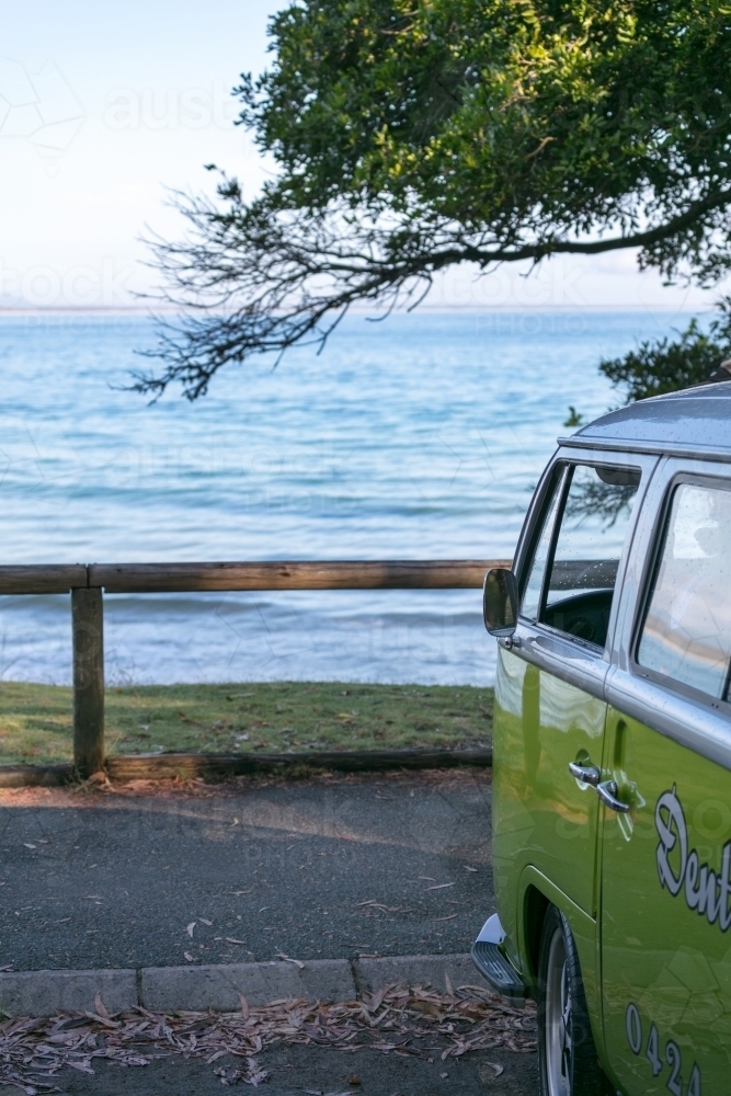 Combi van parked in front of surf spot at Noosa Heads - Australian Stock Image