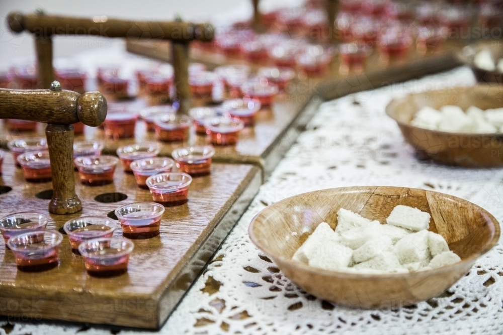 Communion cups of juice in trays and bread for a church service - Australian Stock Image
