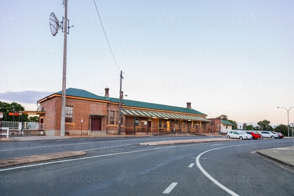 Commuters cars parked in front of country train station - Australian Stock Image