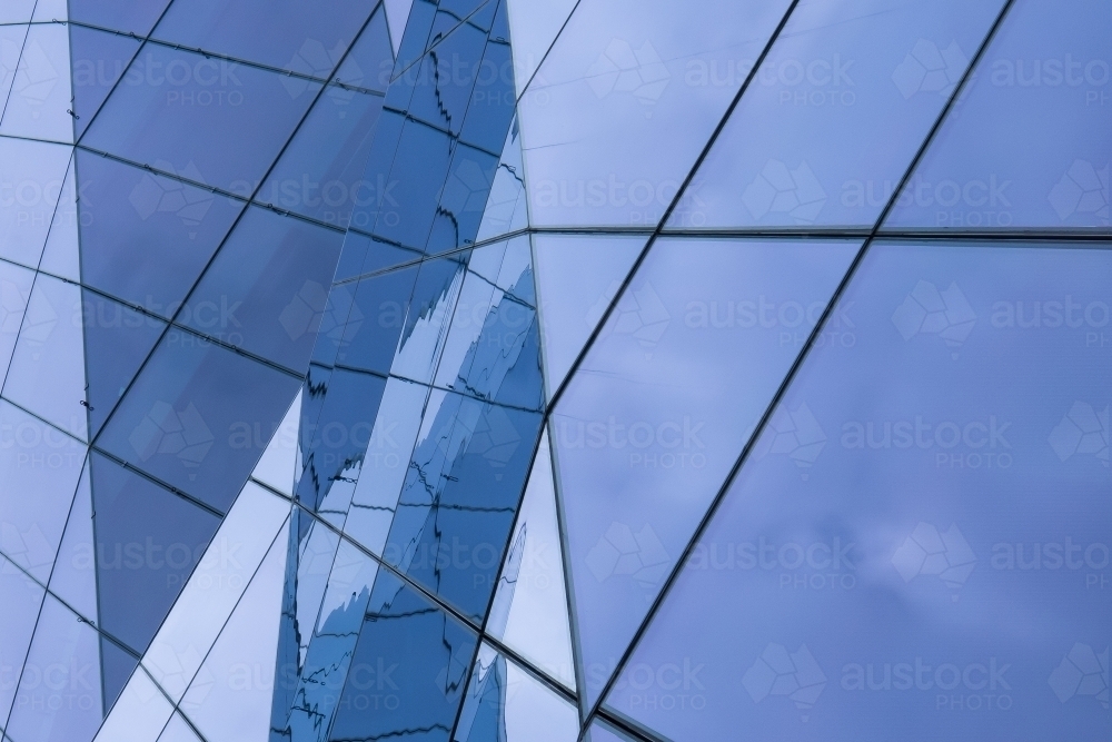 Complex Glass Facade with Reflections of the Sky - Australian Stock Image