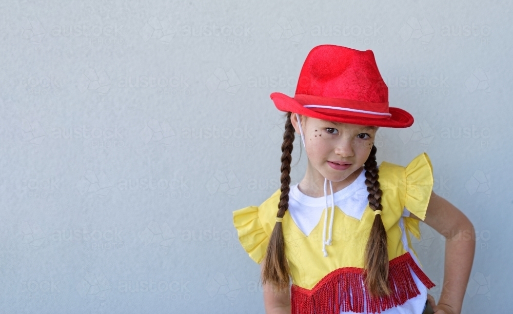 Concert Rehearsal for a school play with a young  girl posing in her fancy cowboy costume - Australian Stock Image