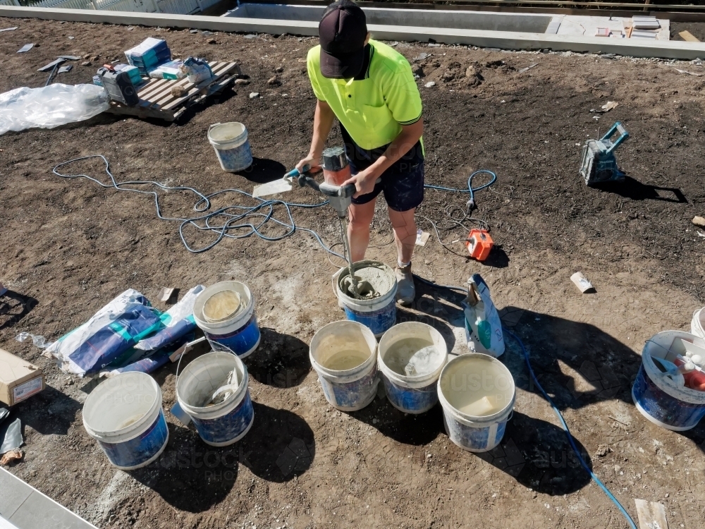 Concrete mixing and pool building with cement by hand with tradies - Australian Stock Image