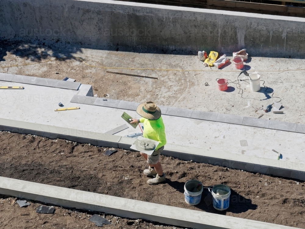 Concrete mixing and pool building with cement by hand with tradies - Australian Stock Image