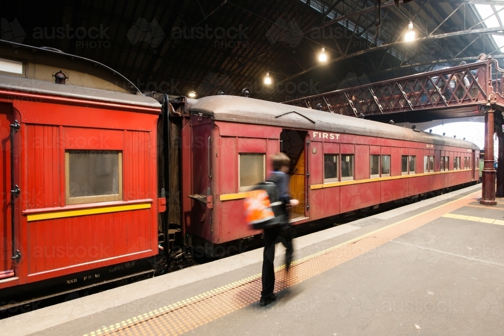 Conductor walking past a heritage carriage on a platform - Australian Stock Image