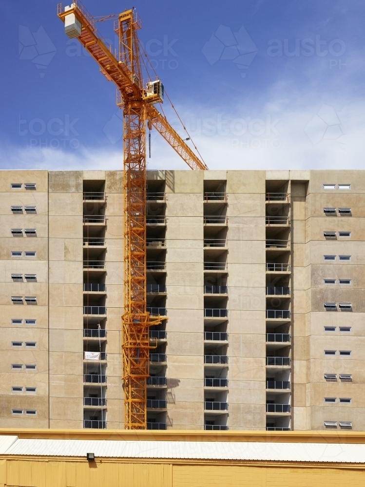 Constructing a high-rise building with crane and blue sky - Australian Stock Image