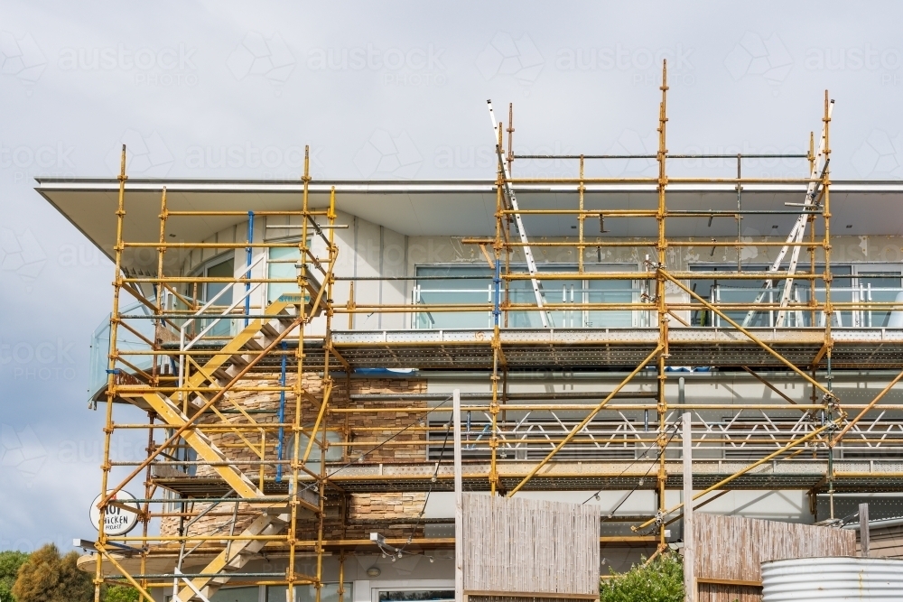 Construction scaffolding covering the side of a new high rise building - Australian Stock Image