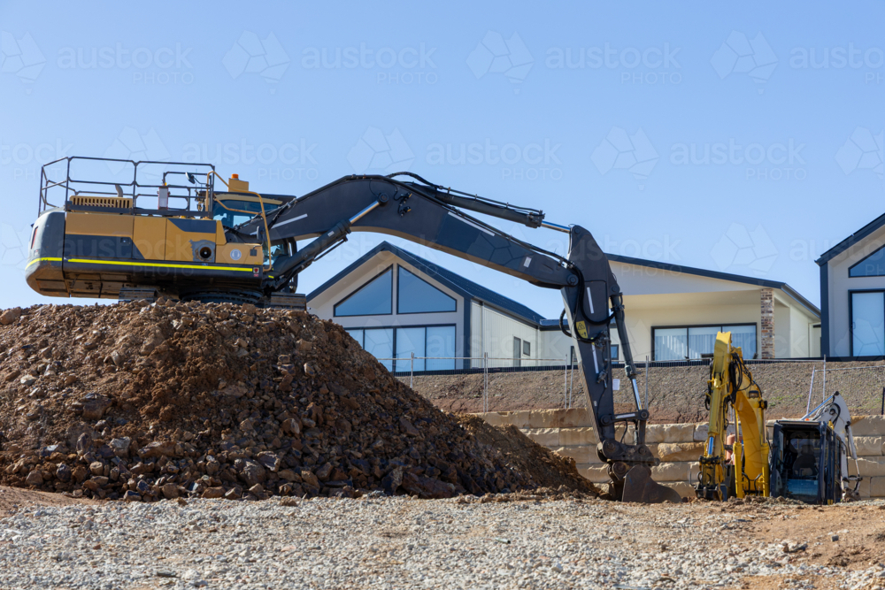 Construction site with digger levelling out ground for house build - Australian Stock Image
