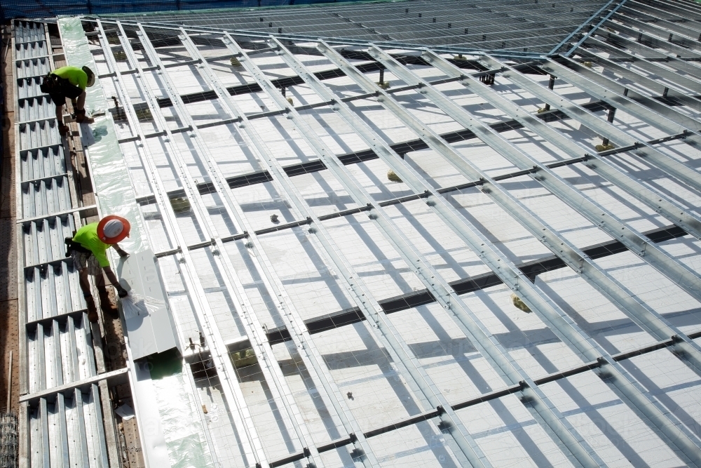Construction workers with metal framework on an industrial building site - Australian Stock Image