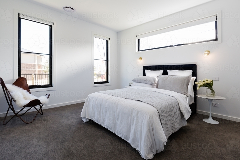 Contemporary master bedroom suite in a luxury home - Australian Stock Image
