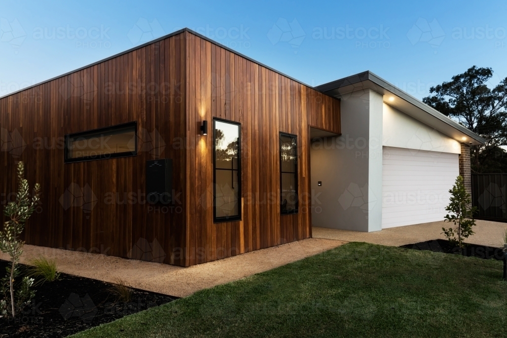 Contemporary new home facade at night dusk - Australian Stock Image