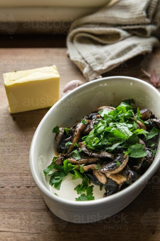 cooked mushrooms with parsley and butter - Australian Stock Image