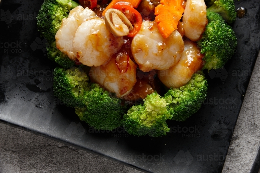 Cooked prawns and vegetables on plate - Australian Stock Image
