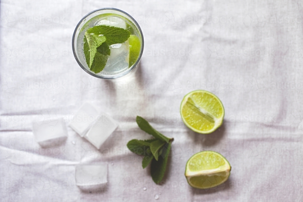 Cool glass of water with ice and mint on tabletop - Australian Stock Image