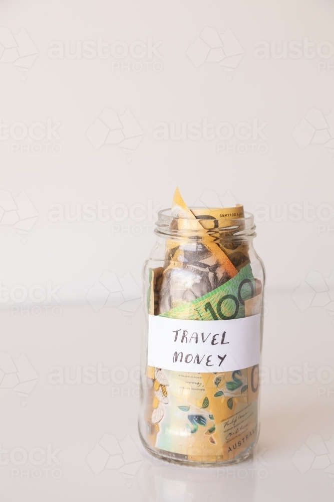 Copy space and jar of australian notes with travel money written on it - Australian Stock Image