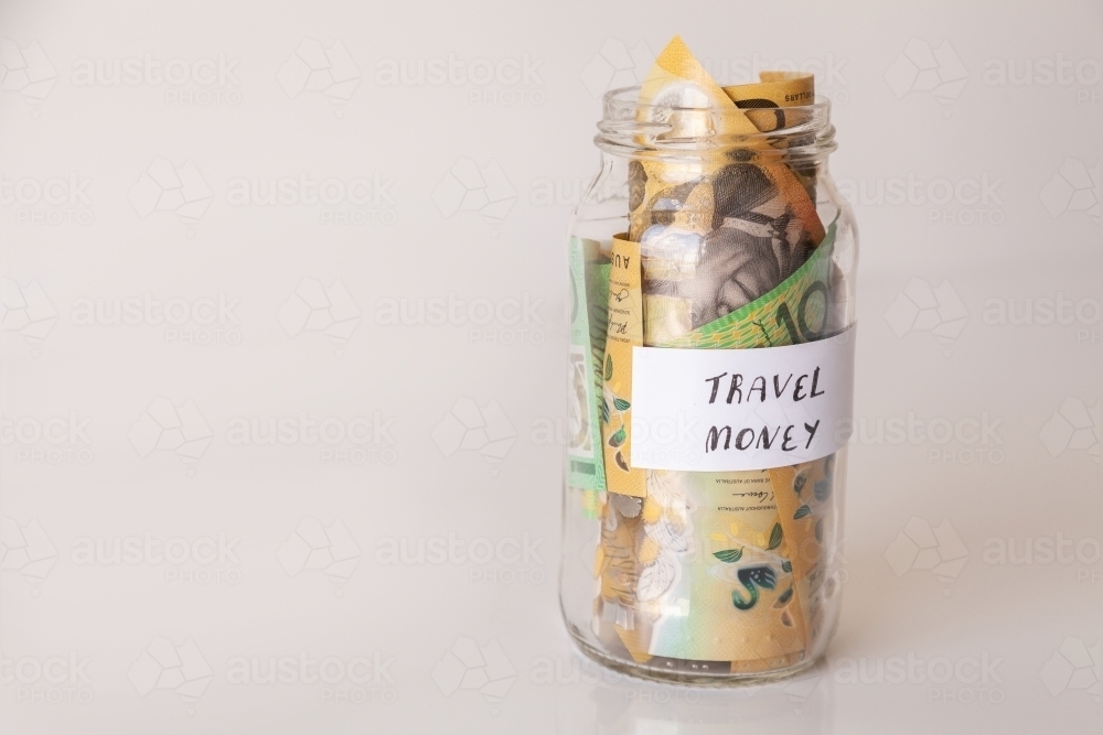 Copy space and jar of australian notes with travel money written on it - Australian Stock Image