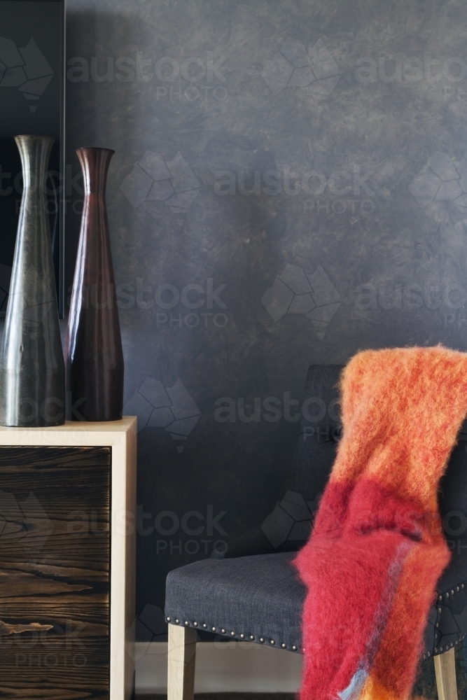 Corner bedroom nook with grey fabric chair and table - Australian Stock Image