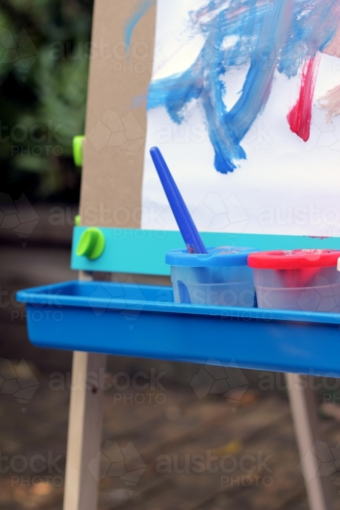 Image of Corner of paint easel tray with pots Austockphoto