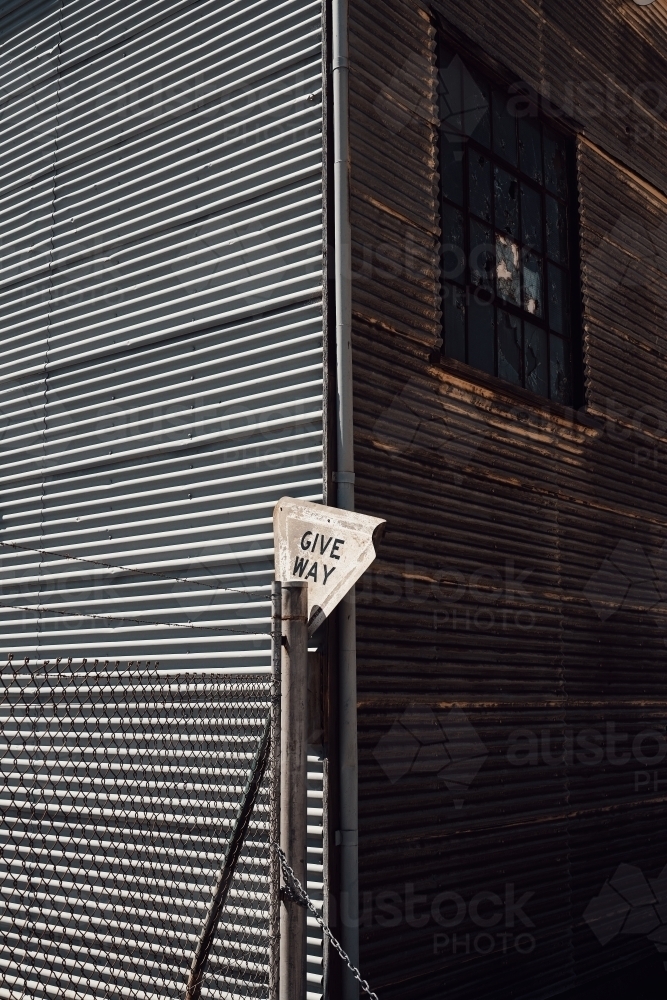 Corrugated iron mining building and fence with a weathered sign - Australian Stock Image