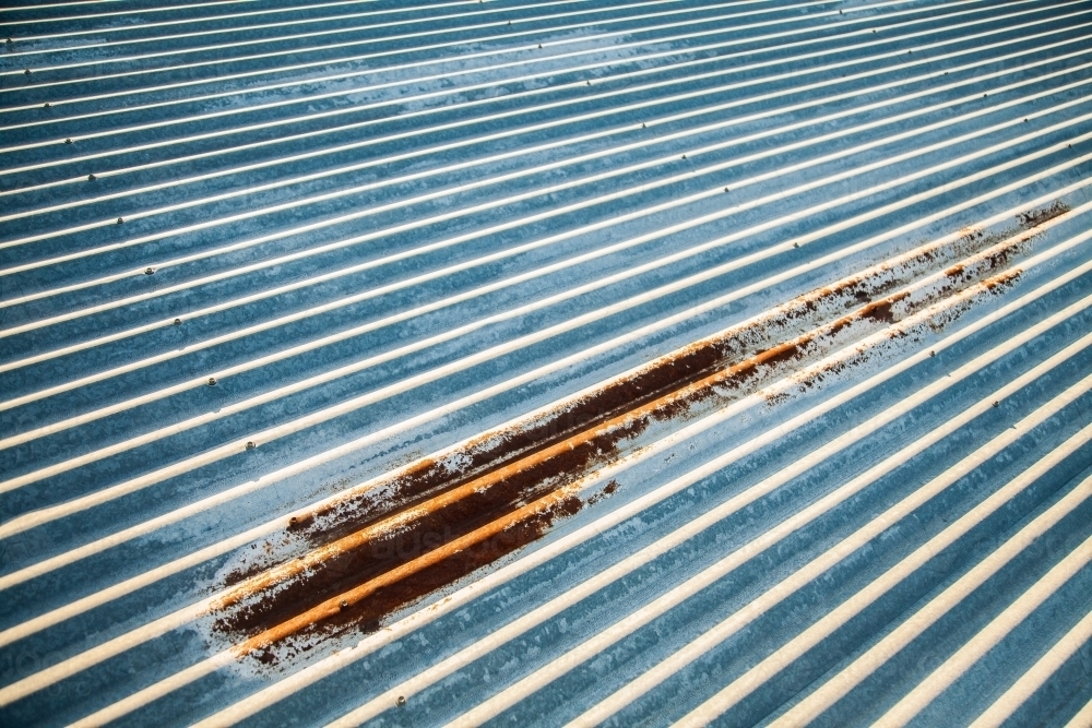 Image of Corrugated iron roof with rusted patch Austockphoto