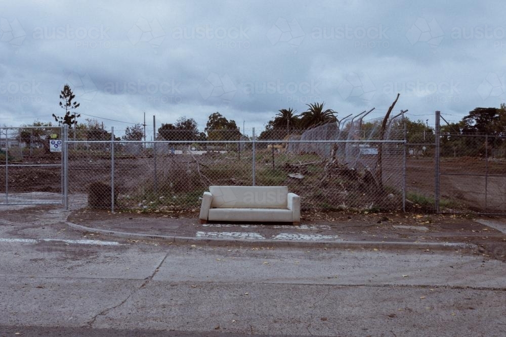 Couch dumped beside a road - Australian Stock Image