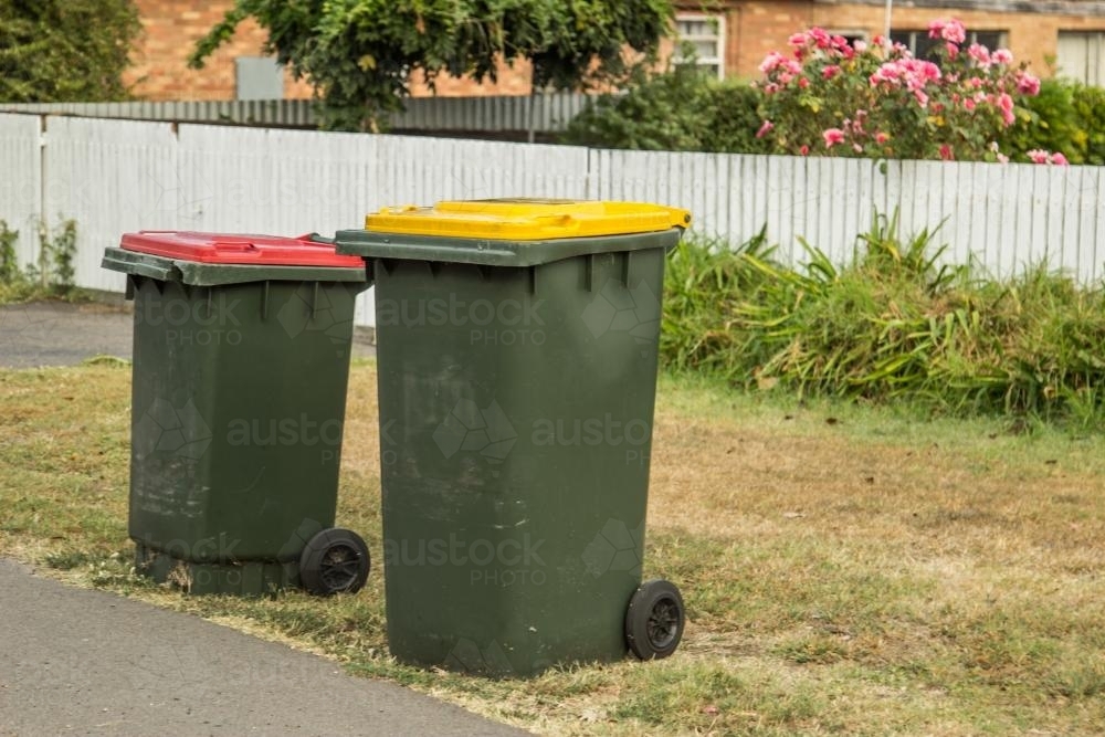Image of Council bins waiting for collection beside a road Austockphoto