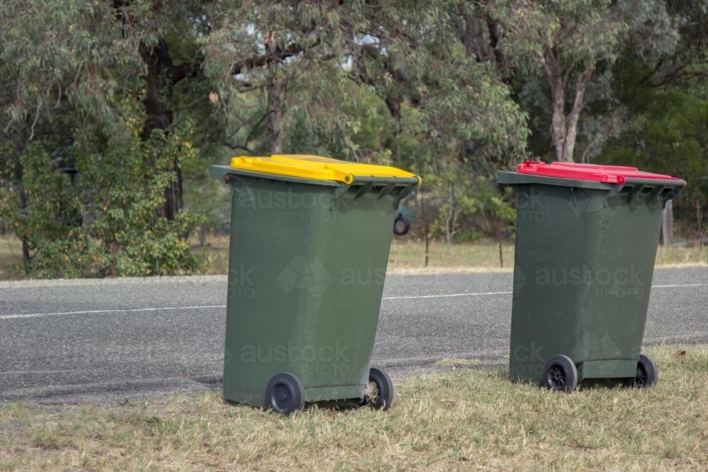 Council bins waiting for collection beside a rural road - Australian Stock Image