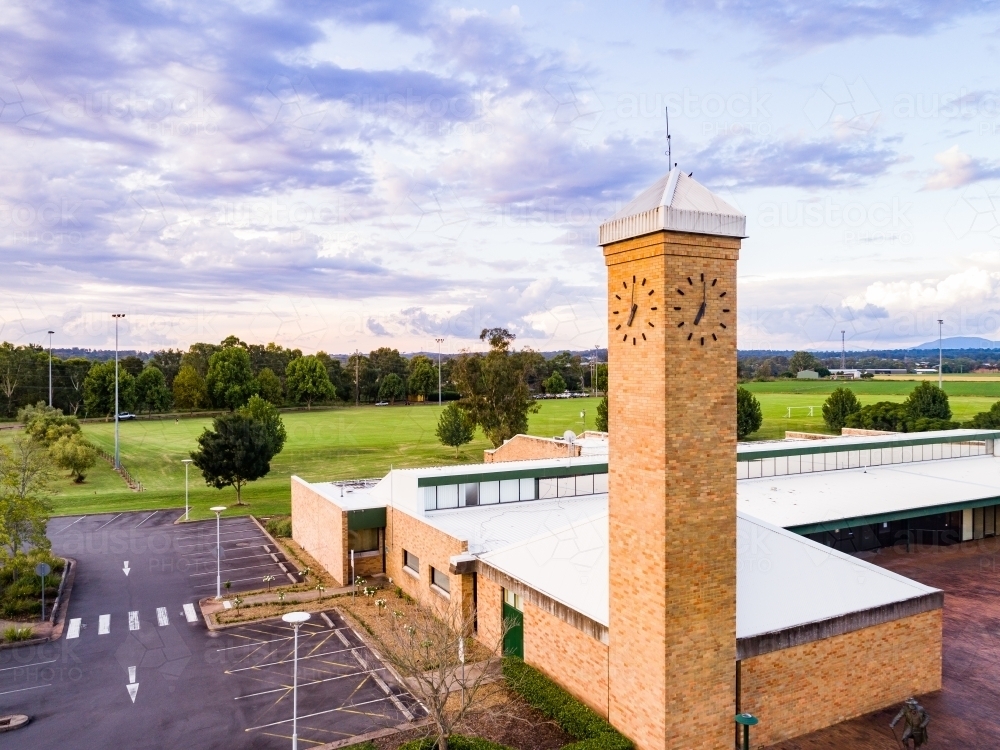Council building with clock tower at dusk with pastel purple clouds - Australian Stock Image
