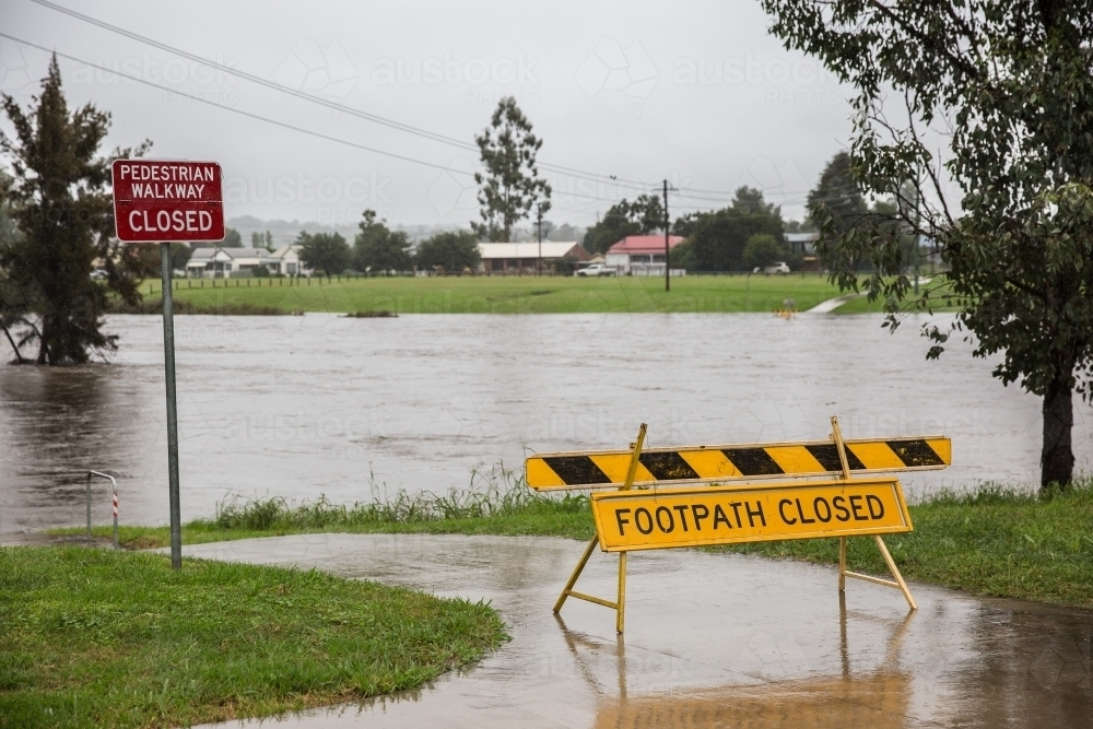 Council signs stating footpath closed due to extreme weather water flooding - Australian Stock Image