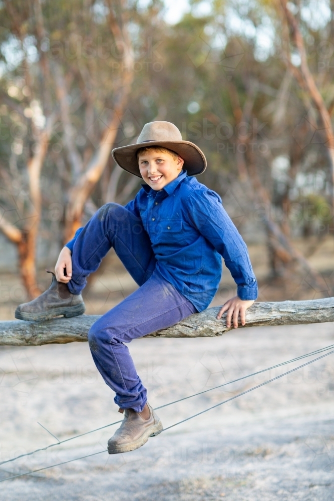 Country boy sitting on a fence - Australian Stock Image