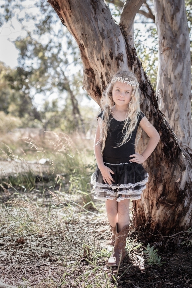 Country girl wearing boots standing near a gum tree in the bush - Australian Stock Image
