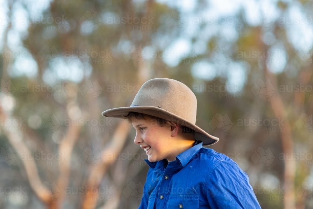 Country kid wearing felt hat head and shoulders in profile - Australian Stock Image