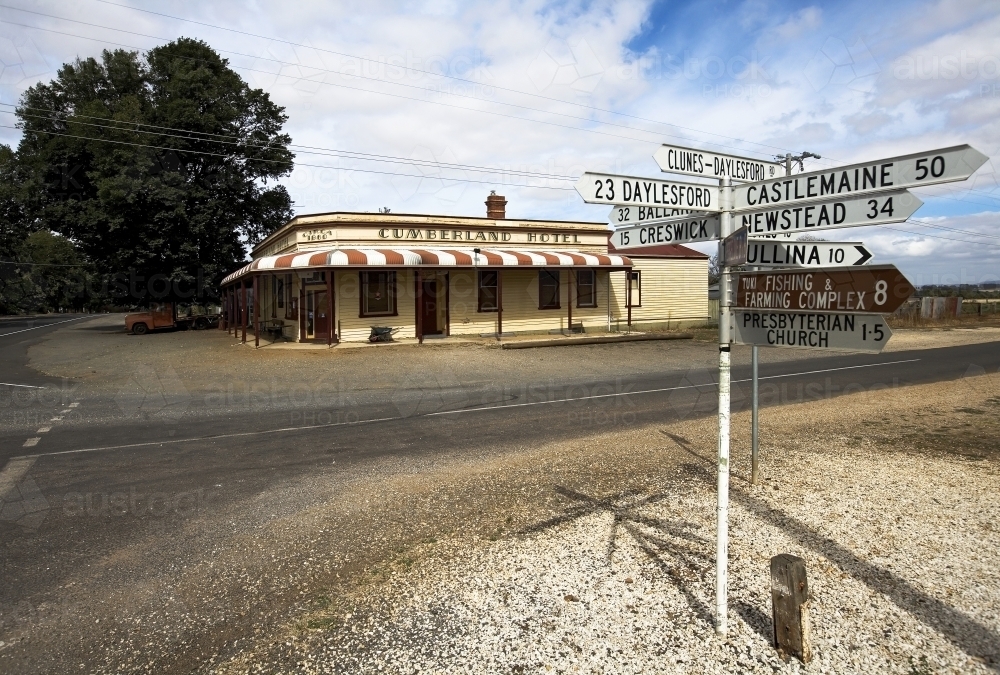 Country pub and sign post at intersection - Australian Stock Image