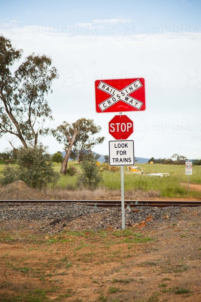Country railway trainline crossing look for trains stop sign - Australian Stock Image