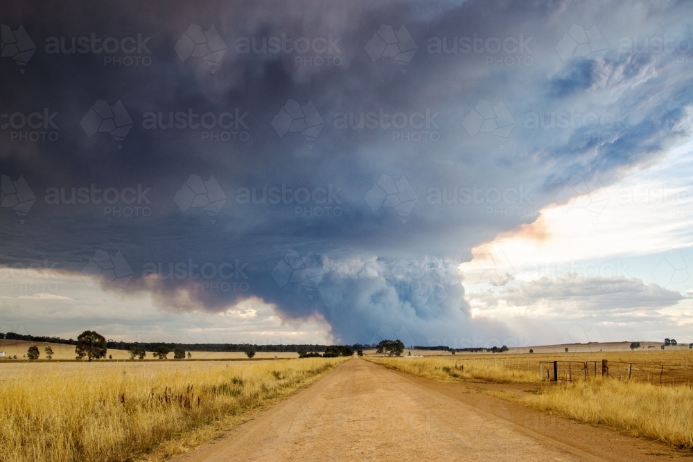 Country road and sky filled with smoke from bushfire - Australian Stock Image