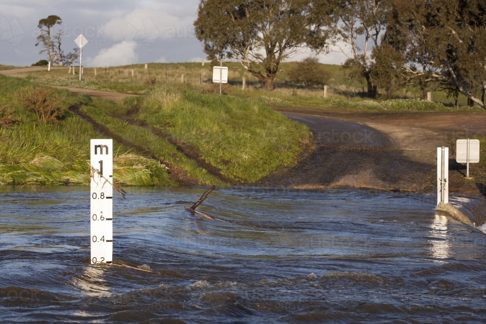 Country road through flooded causeway - Australian Stock Image