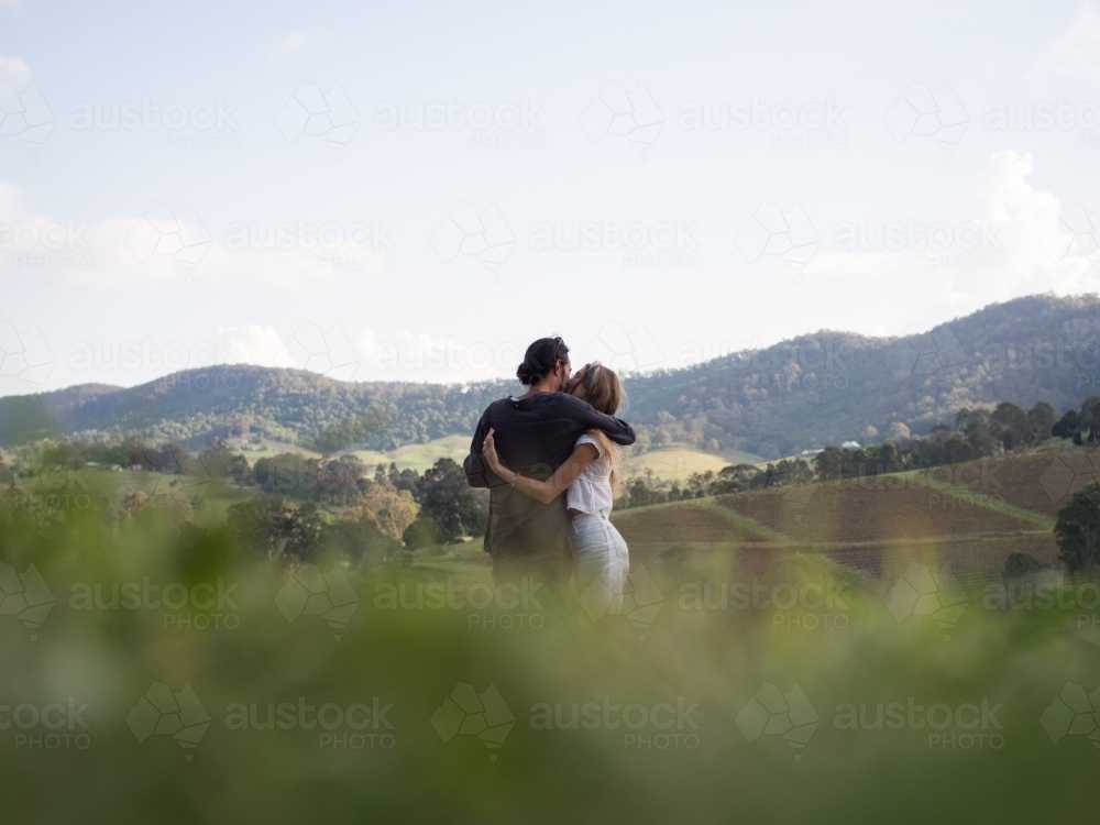 Couple cuddling whilst enjoying the view in Hunter Valley - Australian Stock Image