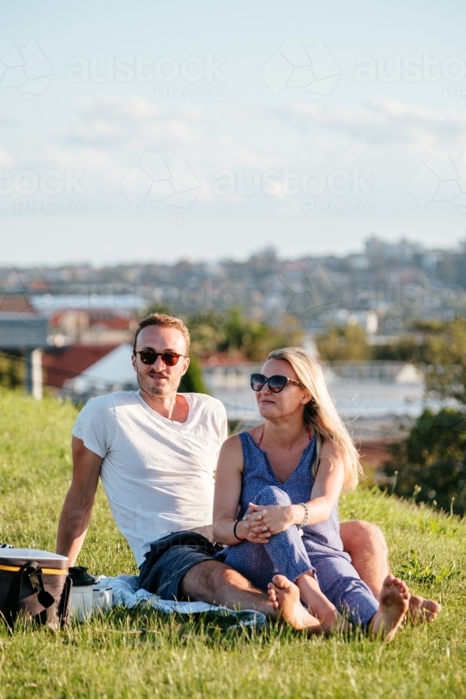 Couple having a picnic on the grass - Australian Stock Image