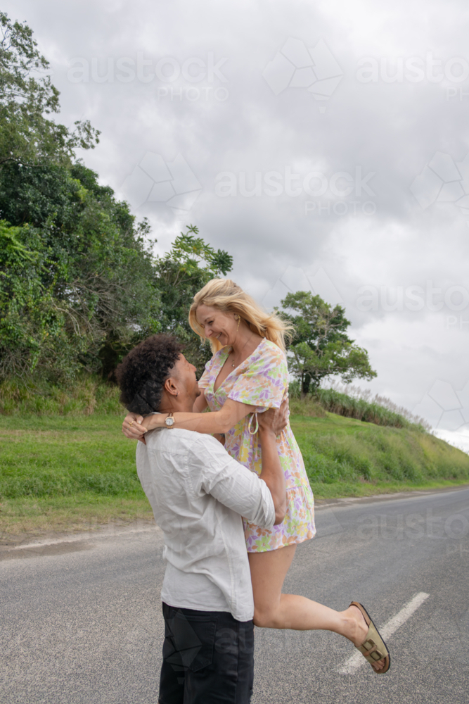 Couple in love hugging on the road - Australian Stock Image